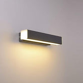 Close-up of adjustable 350° LED wall sconce in a contemporary bedroom